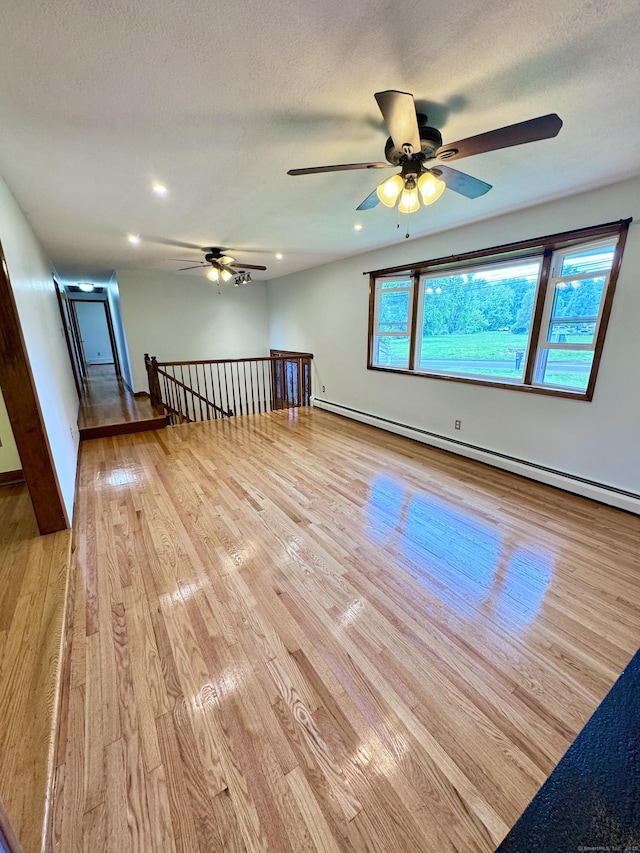 588 Poquonock Ave, Windsor, CT 06095 - unfurnished room featuring a ceiling fan, light wood-style floors, baseboard heating, recessed lighting, and baseboards