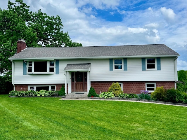 588 Poquonock Ave, Windsor, CT 06095 - split foyer home featuring a front yard, a chimney, and brick siding