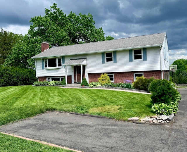 588 Poquonock Ave, Windsor, CT 06095 - raised ranch with a chimney, a front lawn, and brick siding