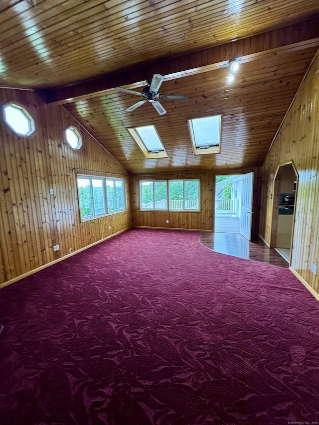 588 Poquonock Ave, Windsor, CT 06095 - carpeted spare room with a ceiling fan, wood walls, vaulted ceiling, wood ceiling, and a skylight