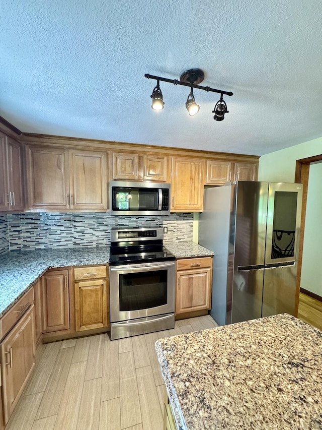 588 Poquonock Ave, Windsor, CT 06095 - kitchen with stainless steel appliances, light wood-style floors, tasteful backsplash, light stone countertops, and a textured ceiling