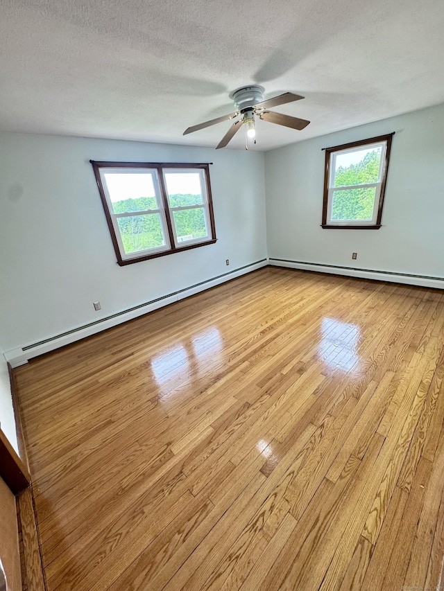 588 Poquonock Ave, Windsor, CT 06095 - unfurnished room featuring baseboard heating, plenty of natural light, light wood finished floors, ceiling fan, and a textured ceiling
