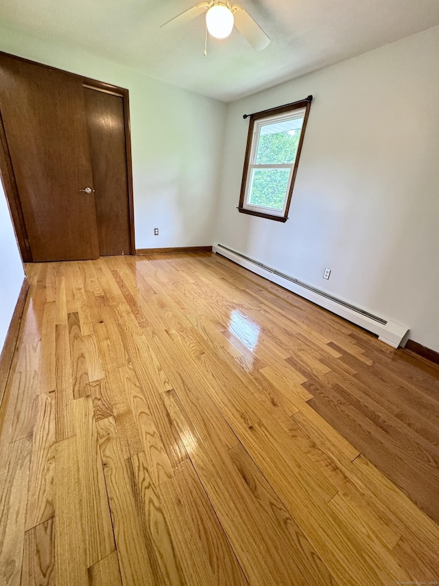 588 Poquonock Ave, Windsor, CT 06095 - unfurnished bedroom with baseboard heating, light wood-style floors, baseboards, and a ceiling fan