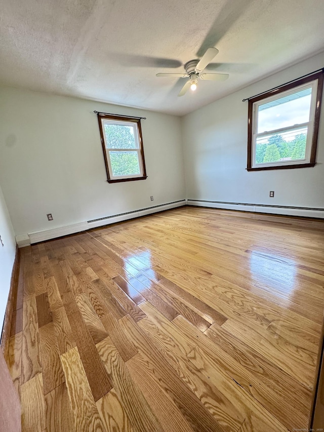 588 Poquonock Ave, Windsor, CT 06095 - spare room with wood finished floors, a ceiling fan, a textured ceiling, baseboards, and baseboard heating
