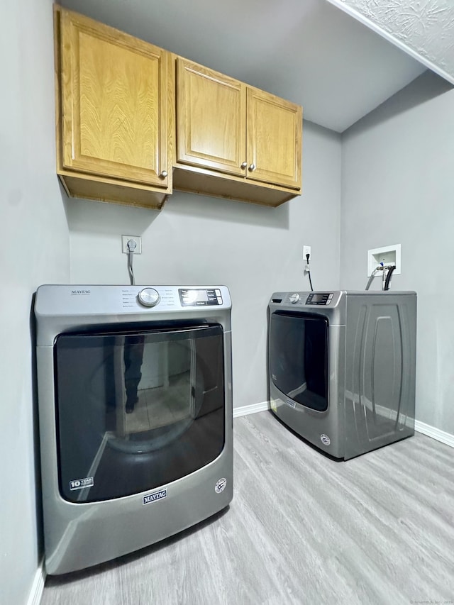 588 Poquonock Ave, Windsor, CT 06095 - washroom with cabinet space, wood finished floors, baseboards, and washing machine and dryer