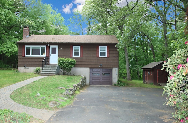 179 N Moodus Rd, East Haddam, CT 06469 - view of front of property with driveway, a chimney, a garage, a front yard, and a storage shed