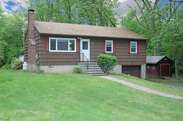 179 N Moodus Rd, East Haddam, CT 06469 - view of front facade with a garage, a chimney, a front lawn, entry steps, and driveway