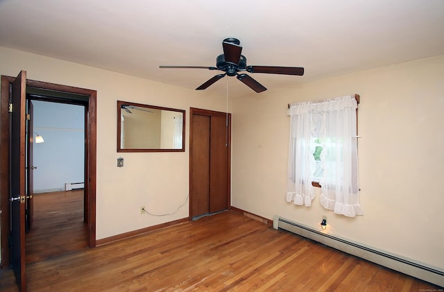 179 N Moodus Rd, East Haddam, CT 06469 - unfurnished bedroom with baseboard heating, light wood-style floors, baseboards, and a closet