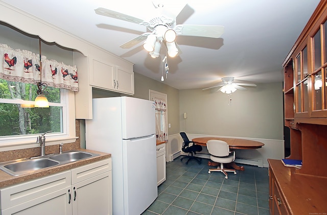 179 N Moodus Rd, East Haddam, CT 06469 - kitchen featuring freestanding refrigerator, a sink, dark tile patterned floors, ceiling fan, and white cabinetry