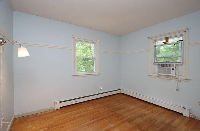179 N Moodus Rd, East Haddam, CT 06469 - empty room with a baseboard heating unit, wood finished floors, and cooling unit