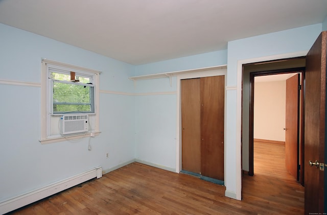 179 N Moodus Rd, East Haddam, CT 06469 - unfurnished bedroom with a baseboard radiator, wood finished floors, and cooling unit