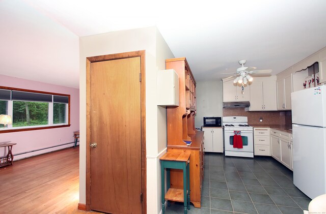 179 N Moodus Rd, East Haddam, CT 06469 - kitchen with white appliances, under cabinet range hood, baseboard heating, white cabinets, and a ceiling fan