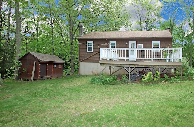 179 N Moodus Rd, East Haddam, CT 06469 - back of property featuring a lawn, a chimney, a deck, and roof with shingles