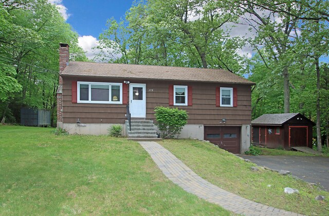 179 N Moodus Rd, East Haddam, CT 06469 - view of front of property with asphalt driveway, a chimney, an attached garage, and a front lawn