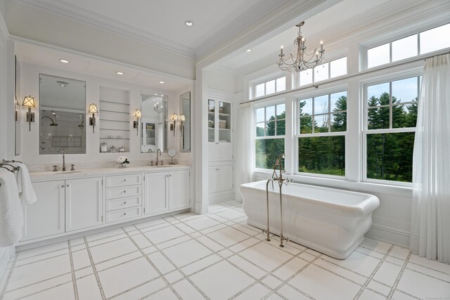 294 Maple Rd, Easton, CT 06612 - full bathroom with a chandelier, a freestanding bath, double vanity, a stall shower, and crown molding