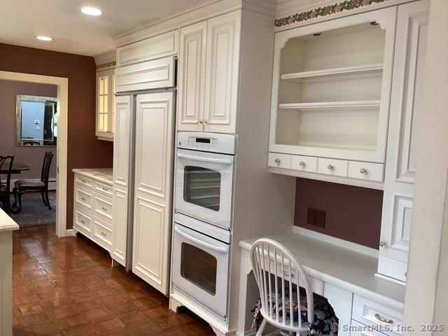 2 Tunxis Pl, Cheshire, CT 06410 - kitchen featuring double oven, light countertops, recessed lighting, white cabinetry, and glass insert cabinets