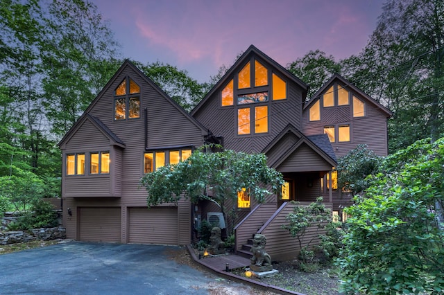 522 Peddlers Rd, Guilford, CT 06437 - view of front of home with asphalt driveway, a garage, stairs, and covered porch