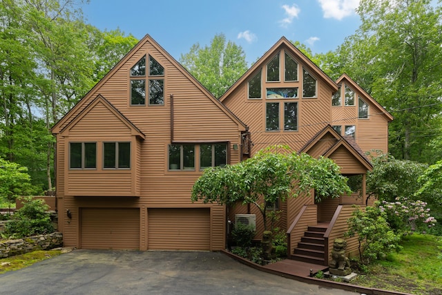 522 Peddlers Rd, Guilford, CT 06437 - rustic home with a garage, driveway, and stairway
