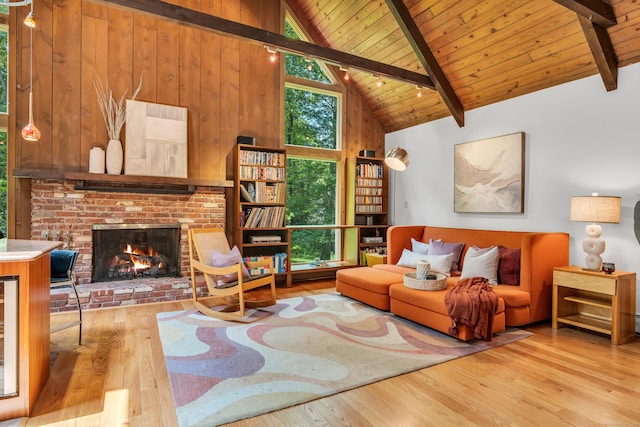 522 Peddlers Rd, Guilford, CT 06437 - living room featuring wood finished floors, a wooden ceiling with exposed beams, a fireplace, wood walls, and high vaulted ceiling