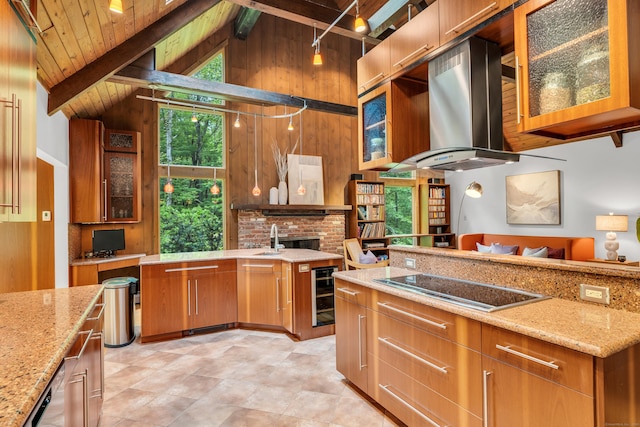 522 Peddlers Rd, Guilford, CT 06437 - kitchen with black electric stovetop, wall chimney exhaust hood, beverage cooler, light stone counters, and brown cabinetry