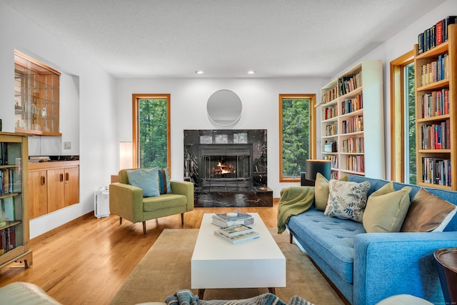 522 Peddlers Rd, Guilford, CT 06437 - living room with wood finished floors, a premium fireplace, plenty of natural light, recessed lighting, and a textured ceiling