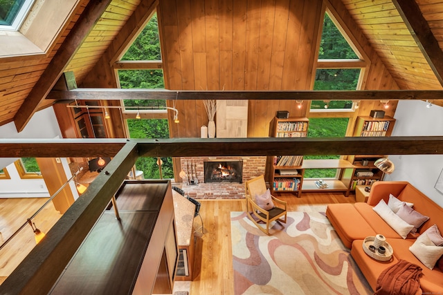 522 Peddlers Rd, Guilford, CT 06437 - living room with wood ceiling, wood finished floors, a baseboard radiator, and a brick fireplace