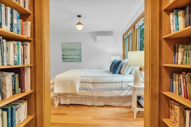 522 Peddlers Rd, Guilford, CT 06437 - bedroom featuring a wall mounted AC and wood finished floors