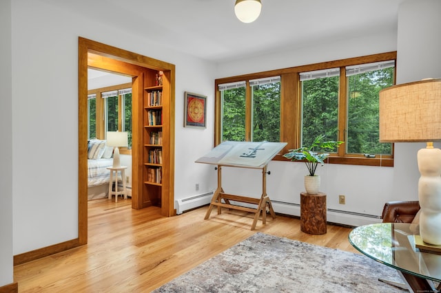 522 Peddlers Rd, Guilford, CT 06437 - living area featuring plenty of natural light, wood finished floors, and baseboard heating