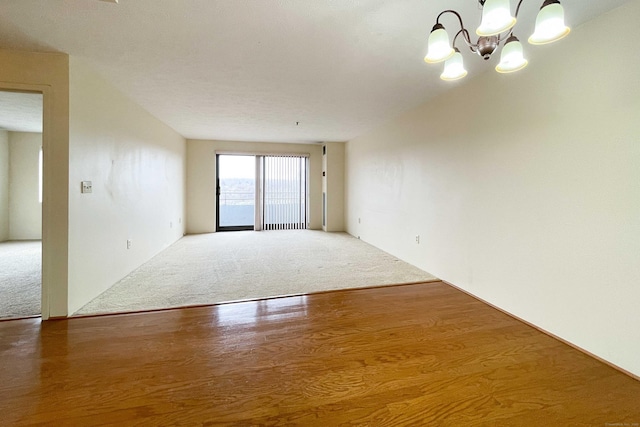 111 Dekoven Dr Apt 506, Middletown, CT 06457 - unfurnished room with a chandelier, wood finished floors, and carpet flooring