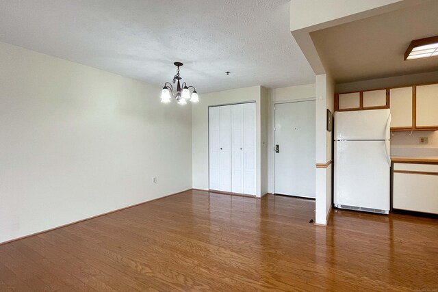 111 Dekoven Dr Apt 506, Middletown, CT 06457 - unfurnished dining area featuring a chandelier and wood finished floors