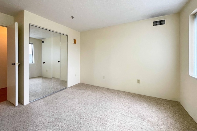 111 Dekoven Dr Apt 506, Middletown, CT 06457 - unfurnished bedroom featuring light colored carpet and a closet