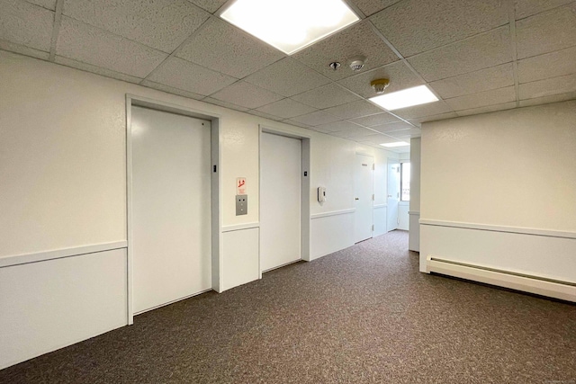 111 Dekoven Dr Apt 506, Middletown, CT 06457 - basement featuring a drop ceiling, elevator, a baseboard heating unit, and carpet floors