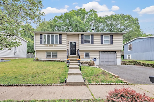 66 Coleman St, West Haven, CT 06516 - bi-level home with a front lawn, driveway, an attached garage, and entry steps
