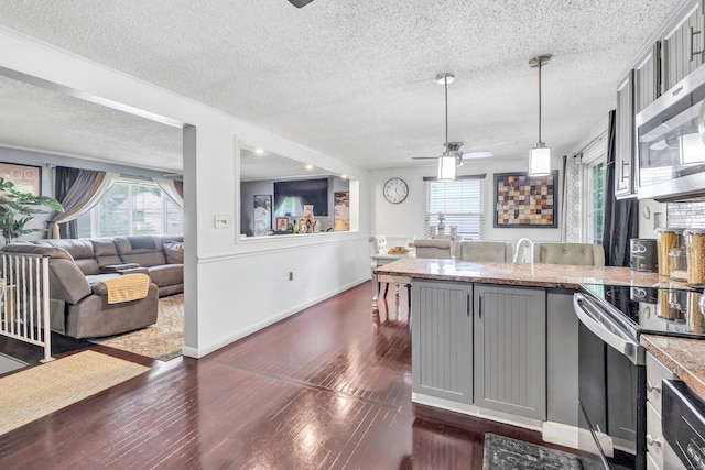 66 Coleman St, West Haven, CT 06516 - kitchen featuring a textured ceiling, gray cabinets, appliances with stainless steel finishes, a peninsula, and open floor plan