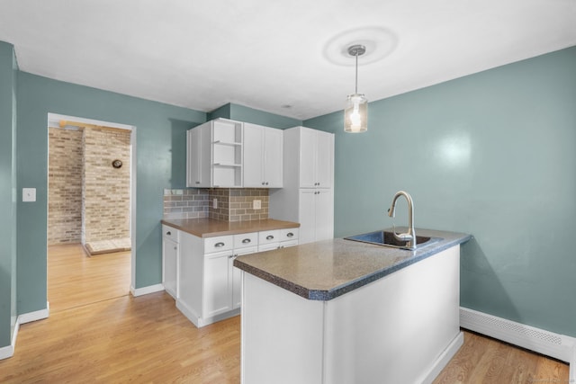 179 Carey Ave, Meriden, CT 06451 - kitchen with a baseboard radiator, light wood-style floors, baseboards, white cabinetry, and open shelves