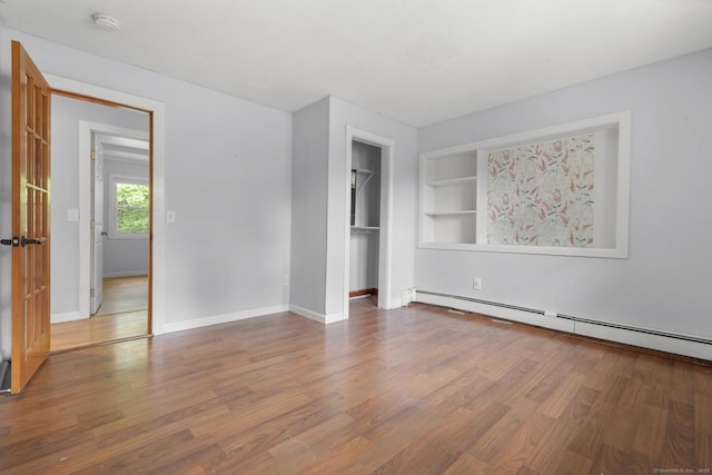 179 Carey Ave, Meriden, CT 06451 - unfurnished bedroom with baseboard heating, wood finished floors, baseboards, and a closet