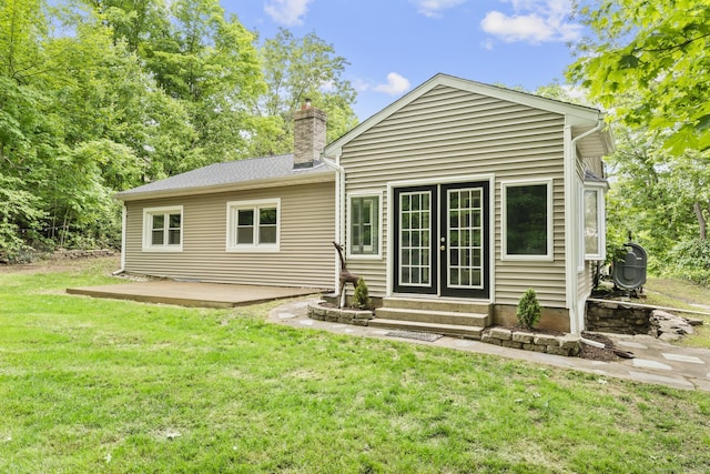 179 Carey Ave, Meriden, CT 06451 - rear view of house featuring entry steps, a chimney, and a yard