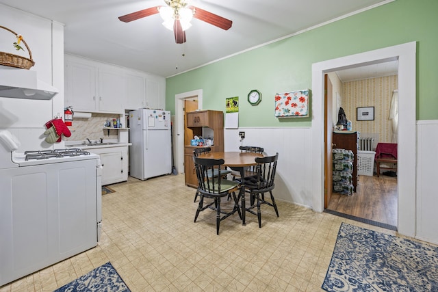 48 Burlington Ave, Bristol, CT 06010 - kitchen featuring white appliances, ceiling fan, wainscoting, white cabinetry, and light flooring