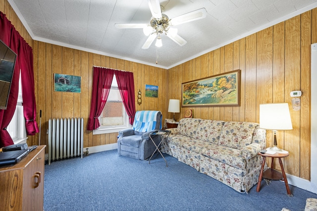 48 Burlington Ave, Bristol, CT 06010 - carpeted living room with radiator heating unit, ceiling fan, ornamental molding, wood walls, and baseboards
