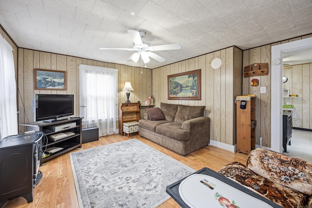 48 Burlington Ave, Bristol, CT 06010 - living room featuring ceiling fan, wood walls, and wood finished floors