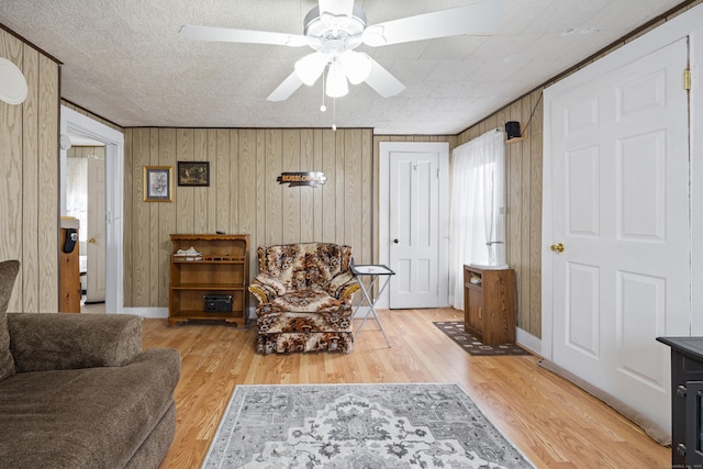 48 Burlington Ave, Bristol, CT 06010 - living area featuring a ceiling fan, wood finished floors, and wooden walls