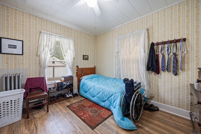 48 Burlington Ave, Bristol, CT 06010 - bedroom featuring crown molding, wood finished floors, radiator heating unit, a ceiling fan, and wallpapered walls