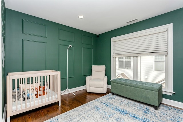 50 Almira Dr Unit B, Greenwich, CT 06831 - bedroom with dark wood-style floors, baseboards, recessed lighting, and a nursery area