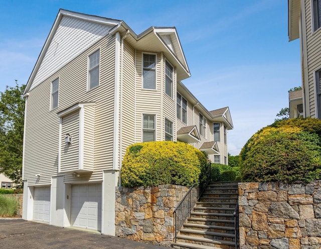 50 Almira Dr Unit B, Greenwich, CT 06831 - view of home's exterior with an attached garage, driveway, and stairs