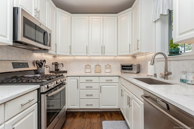 50 Almira Dr Unit B, Greenwich, CT 06831 - kitchen with stainless steel appliances, a sink, white cabinetry, and backsplash