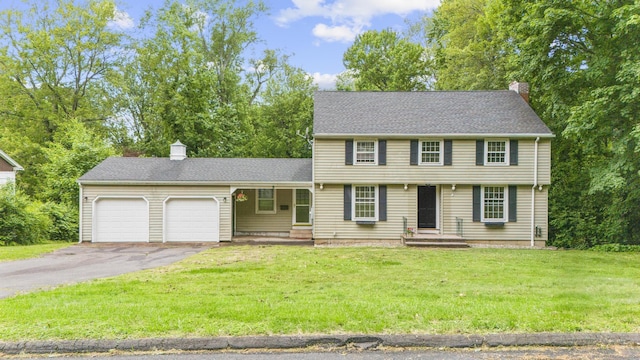 5 Brainerd Dr, Portland, CT 06480 - colonial inspired home featuring a chimney, a garage, asphalt driveway, and a front yard