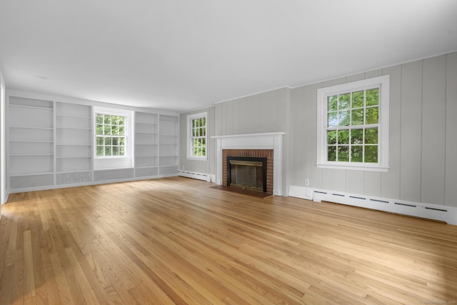 5 Brainerd Dr, Portland, CT 06480 - unfurnished living room featuring a baseboard radiator, light wood-style flooring, a brick fireplace, and plenty of natural light