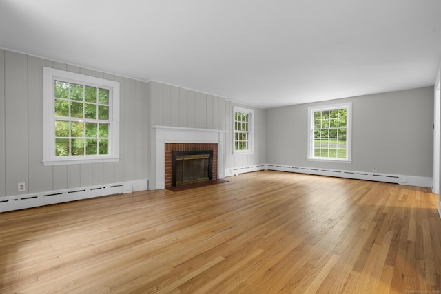5 Brainerd Dr, Portland, CT 06480 - unfurnished living room with wood finished floors, a baseboard radiator, plenty of natural light, and a fireplace