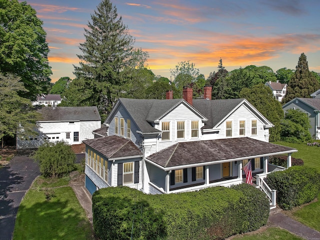 14 W Mystic Ave, Groton, CT 06355 - view of front facade featuring a porch, a chimney, and a lawn