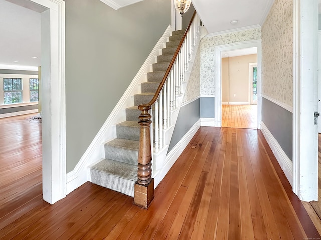 14 W Mystic Ave, Groton, CT 06355 - stairway featuring wallpapered walls, crown molding, hardwood / wood-style floors, and baseboards